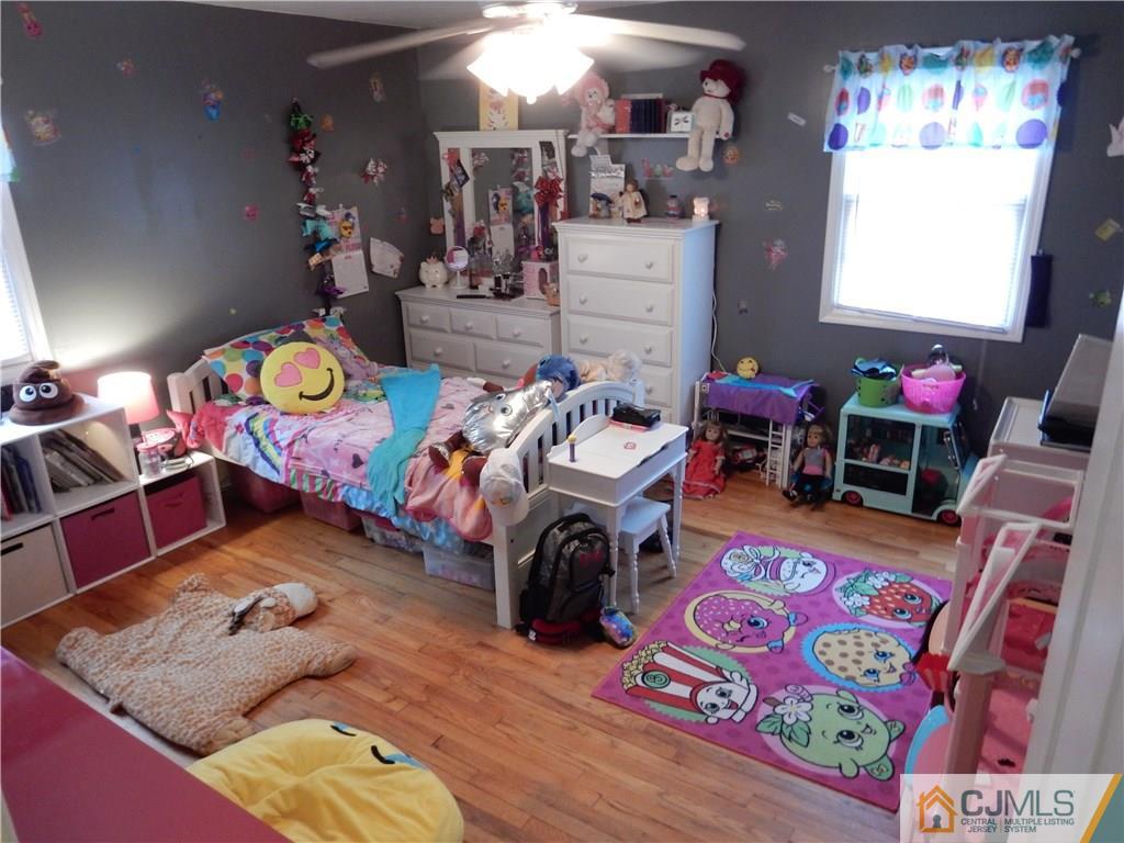 61 Kimberly Road Colonia, NJ 07067 - Photo 11 of 25 a bedroom with furniture and a wooden floor