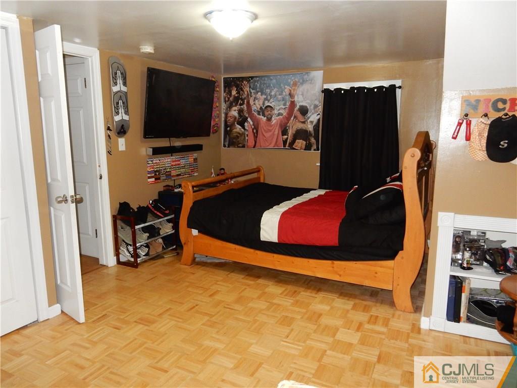 61 Kimberly Road Colonia, NJ 07067 - Photo 13 of 25 a room with furniture and a flat screen tv