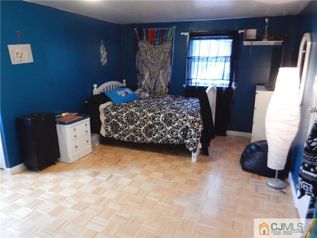 61 Kimberly Road Colonia, NJ 07067 - Photo 15 of 25 a bed sitting in a bedroom next to a window