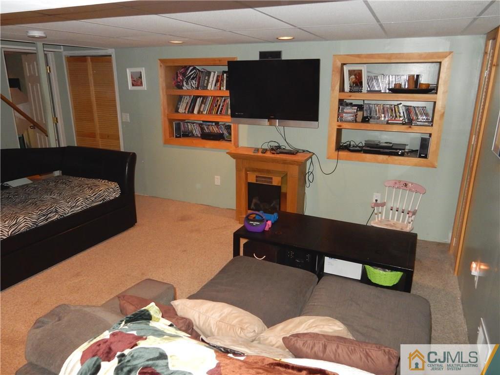 61 Kimberly Road Colonia, NJ 07067 - Photo 18 of 25 a bedroom with a bed and flat screen tv
