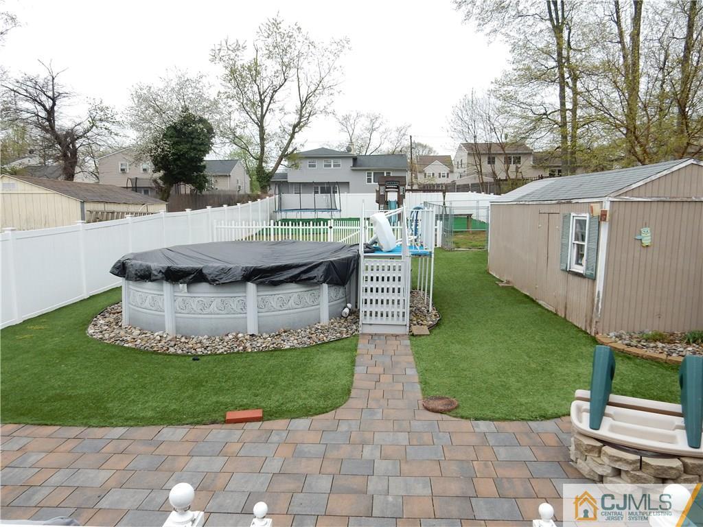 61 Kimberly Road Colonia, NJ 07067 - Photo 22 of 25 a view of a house with a yard and sitting area