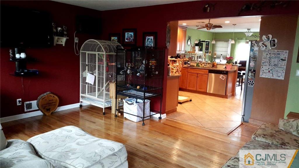 61 Kimberly Road Colonia, NJ 07067 - Photo 25 of 25 a living room with furniture a lamp and wooden floor