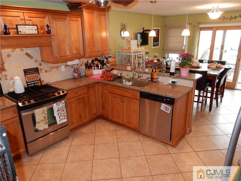 61 Kimberly Road Colonia, NJ 07067 - Photo 4 of 25 a kitchen with stainless steel appliances a sink stove and cabinets