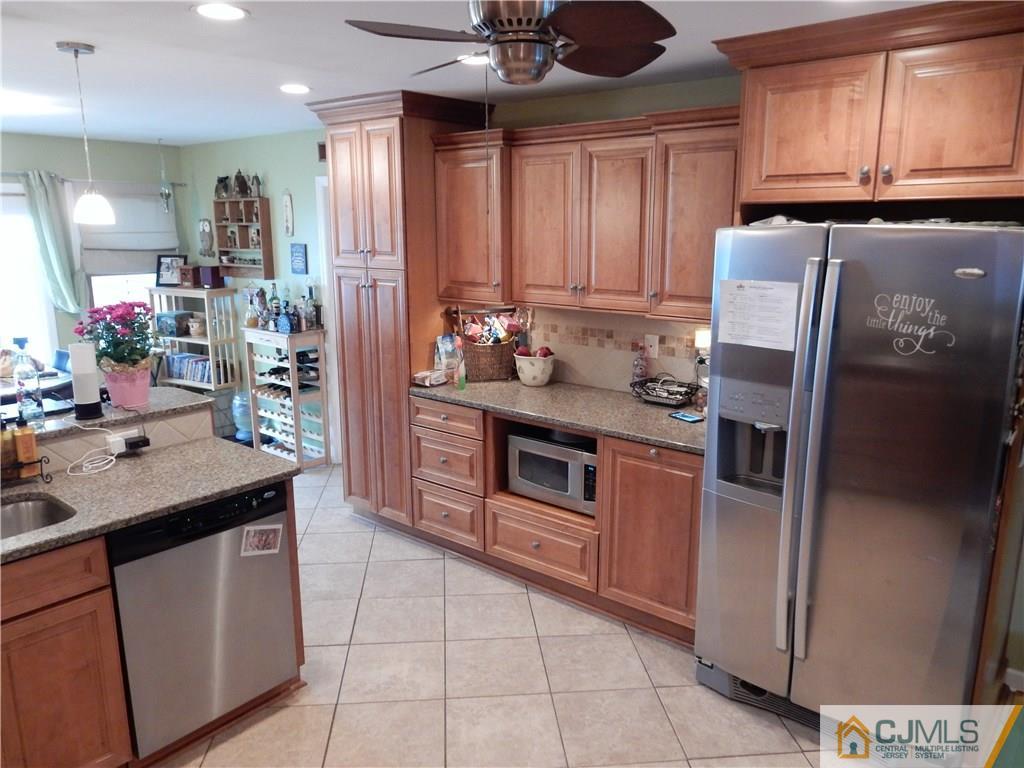 61 Kimberly Road Colonia, NJ 07067 - Photo 6 of 25 a kitchen with stainless steel appliances granite countertop a sink and a refrigerator