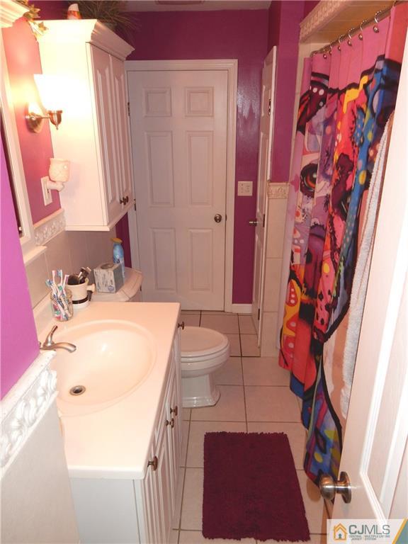 61 Kimberly Road Colonia, NJ 07067 - Photo 8 of 25 a bathroom with a sink and a mirror
