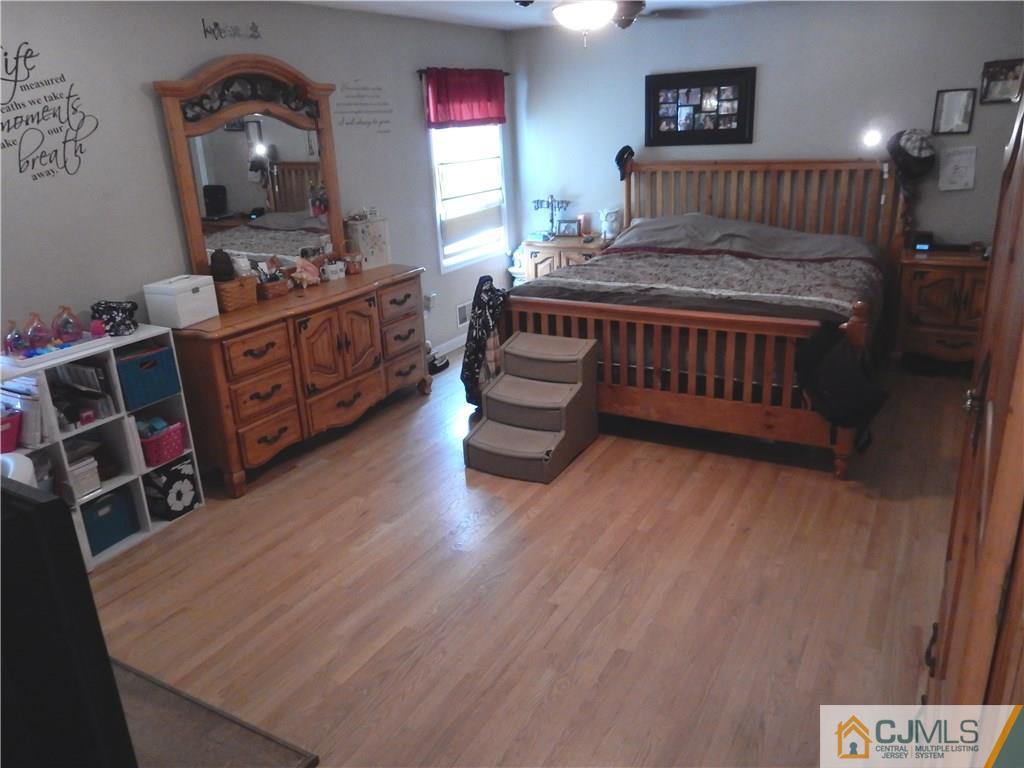 61 Kimberly Road Colonia, NJ 07067 - Photo 9 of 25 a bedroom with a bed and a tv in it