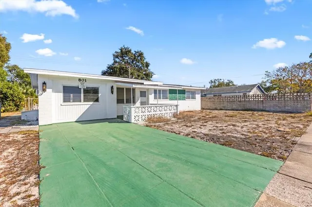 a view of house with backyard and a garden