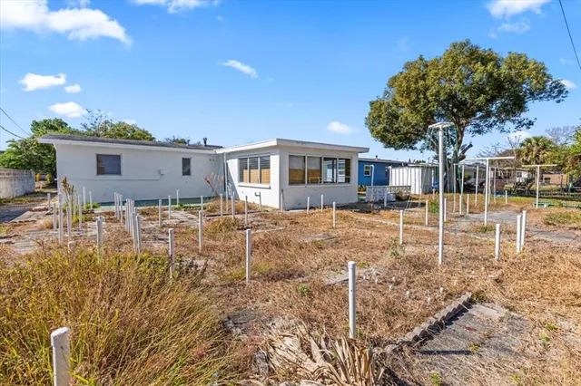 a backyard of a house with table and chairs