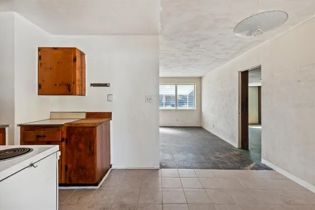 an empty room with windows and cabinet