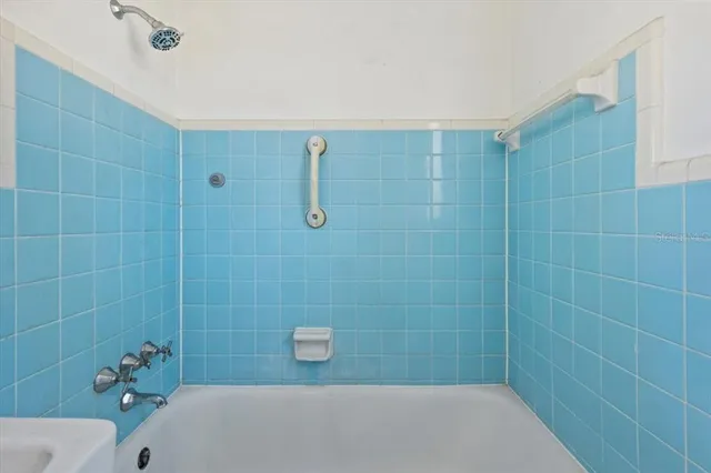 a bathroom with a shower and a sink