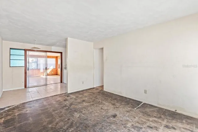 a view of empty room with floor to ceiling window