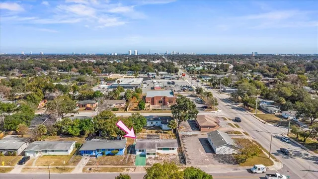 a front view of house with yard and trees in the background