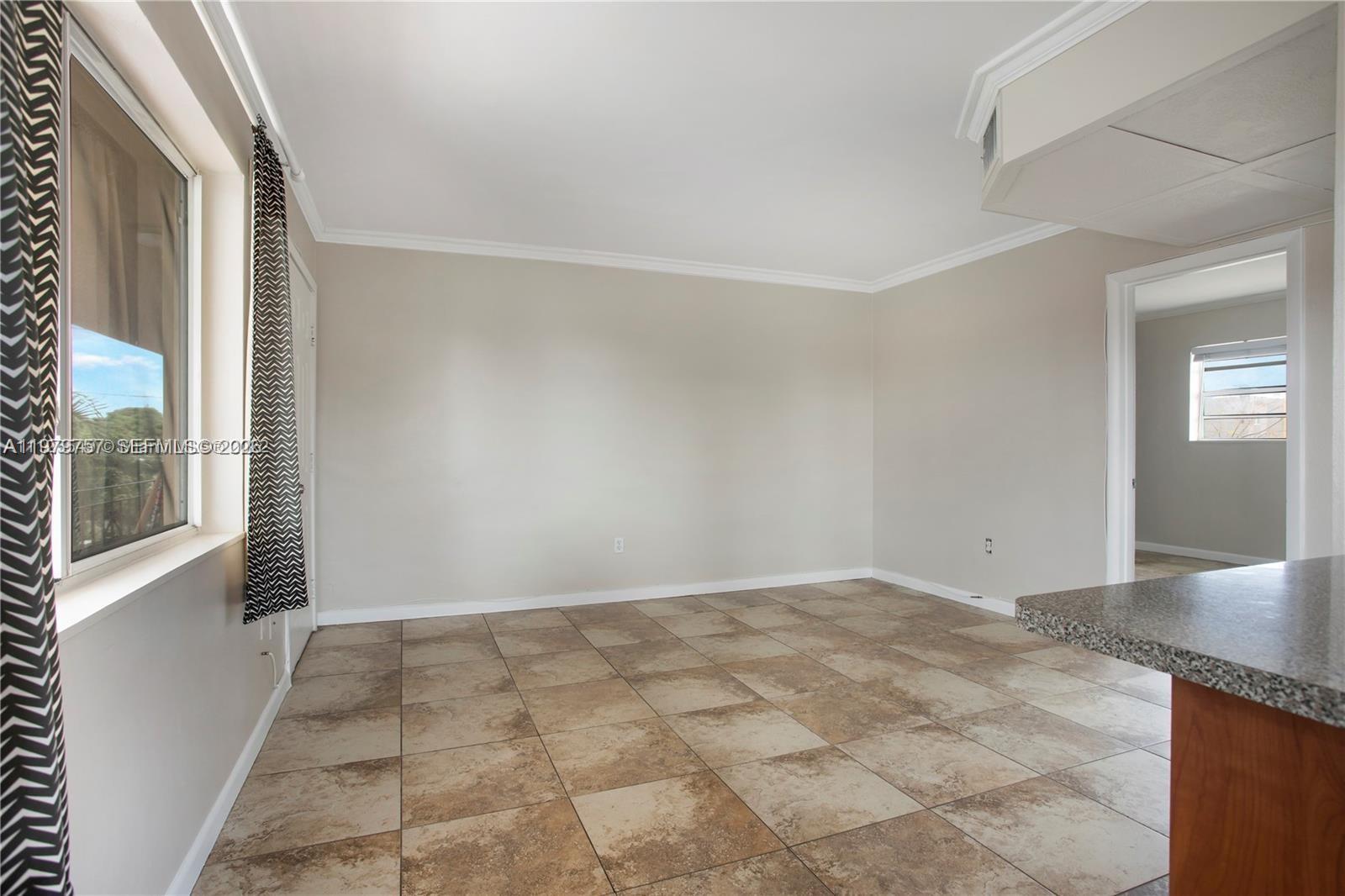 1020 Southwest 7th Street, Unit 9 Miami, FL 33130 - Photo 4 of 13 a view of an empty room with windows