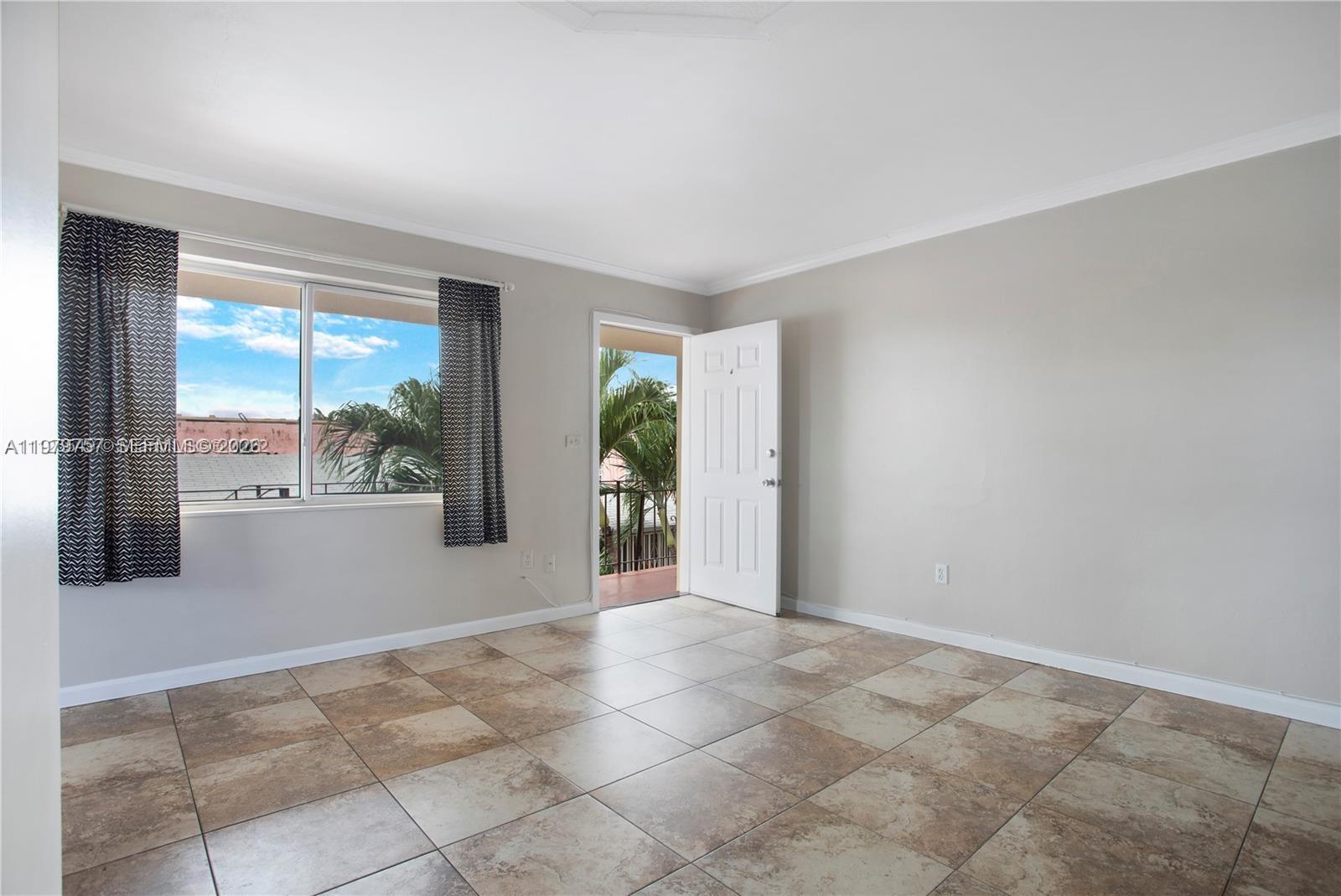 1020 Southwest 7th Street, Unit 9 Miami, FL 33130 - Photo 6 of 13 a view of an empty room with a window