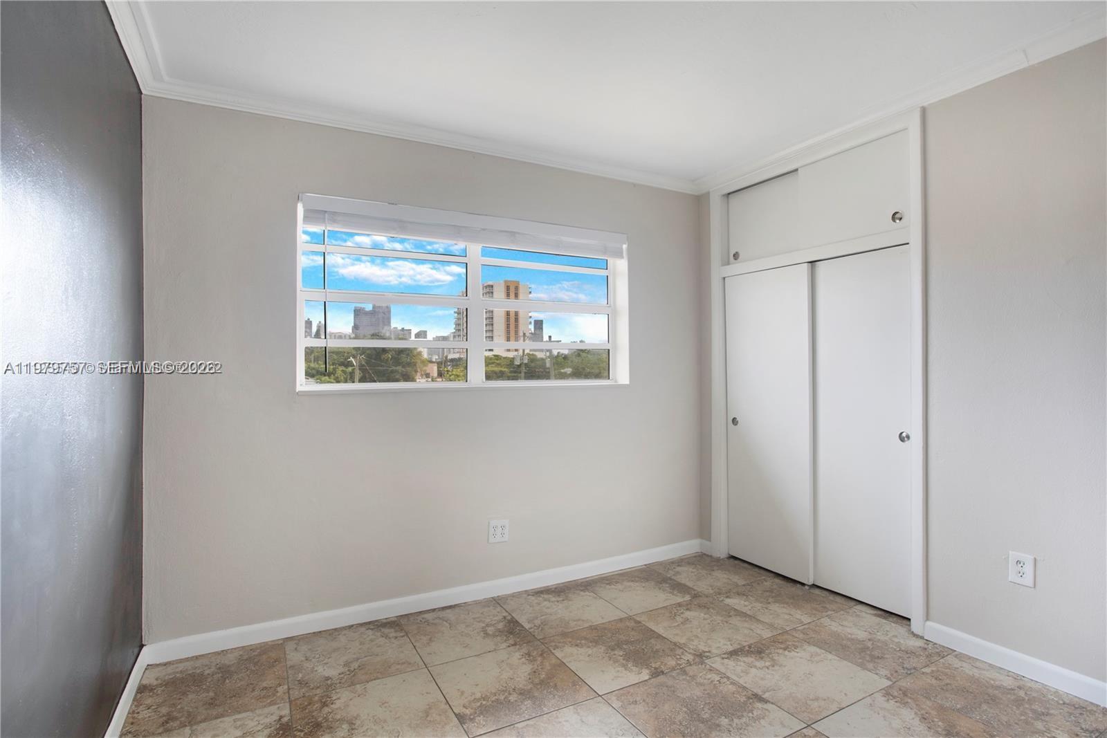 1020 Southwest 7th Street, Unit 9 Miami, FL 33130 - Photo 9 of 13 a view of an empty room with a window
