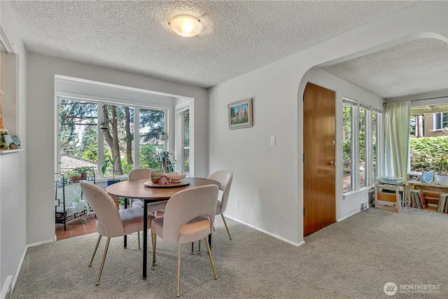 a view of a dining room with furniture and a window