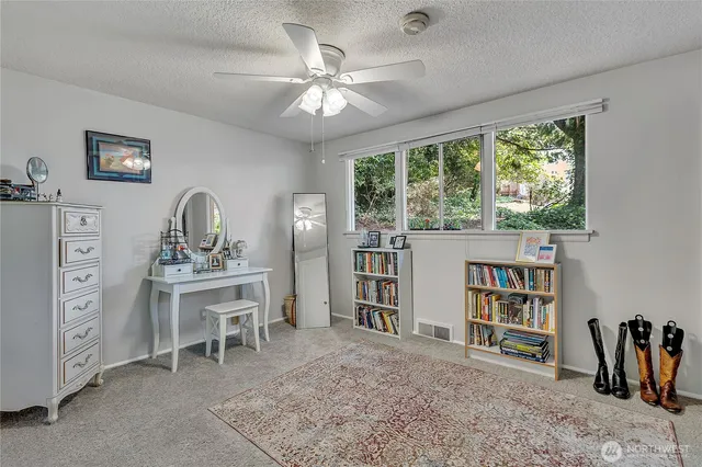a view of a workspace with furniture and a window