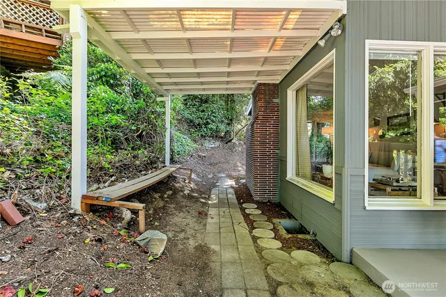 a view of a porch with a wooden floor and roof