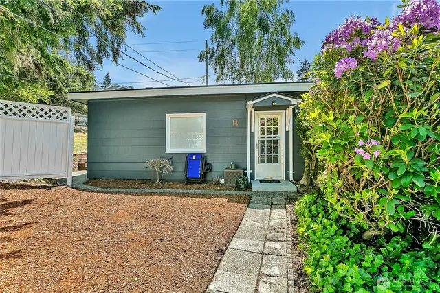 a front view of a house with a yard and a garage