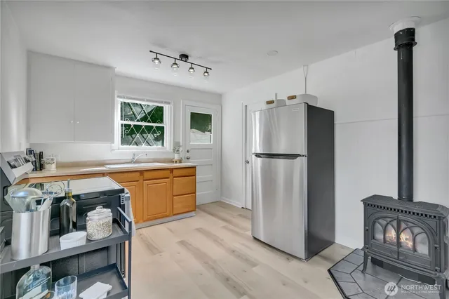a kitchen with refrigerator cabinets and wooden floor