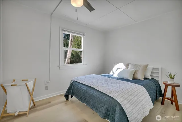 a bedroom with a bed and a window