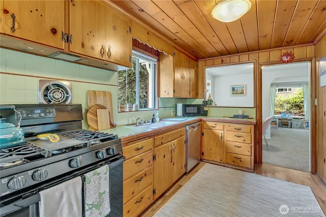 a kitchen with stainless steel appliances granite countertop a stove and a refrigerator