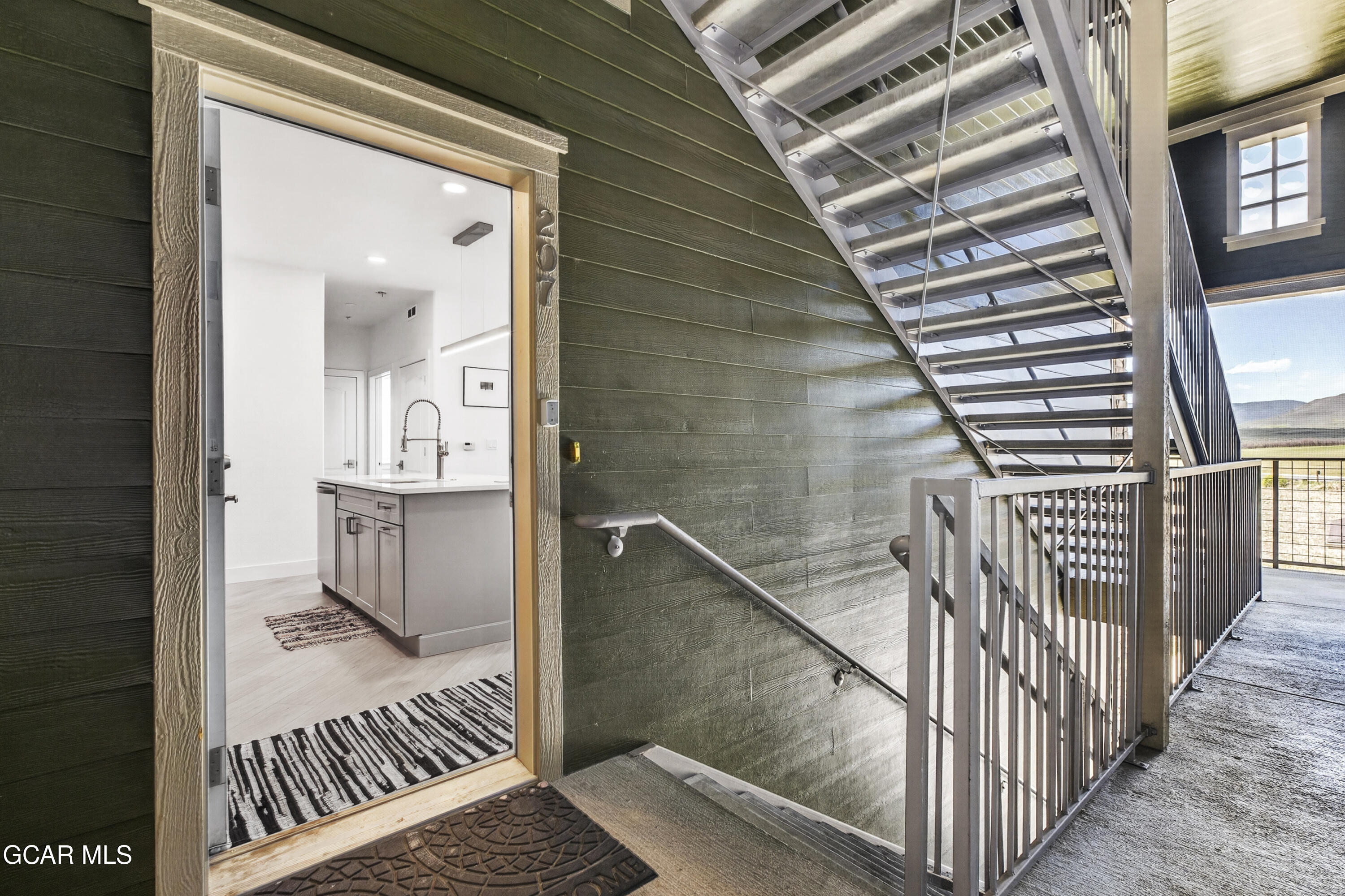 160 Village Road, Unit F207 Granby, CO 80446 - Photo 21 of 28 a view of a hallway with wooden floor and staircase