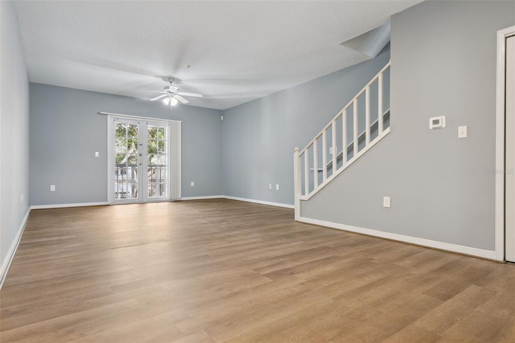 720 Celebration Avenue, Unit 220 Celebration, FL 34747 - Photo 13 of 45 a view of an empty room with wooden floor and a window