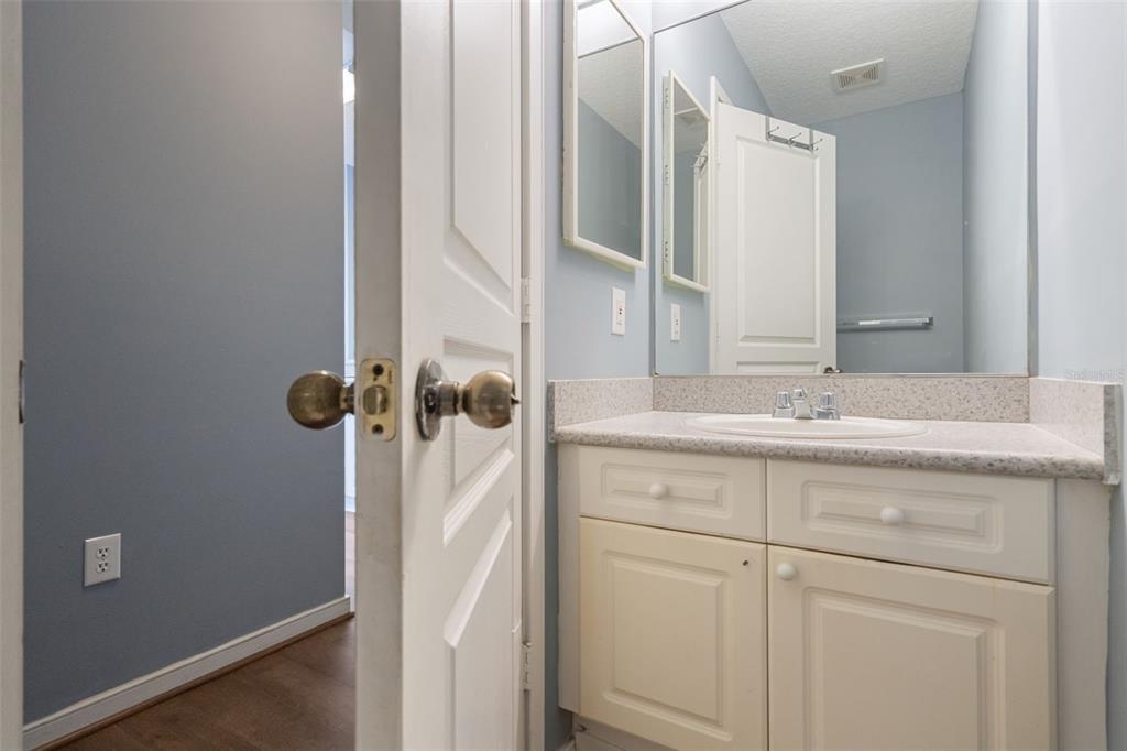 720 Celebration Avenue, Unit 220 Celebration, FL 34747 - Photo 15 of 45 a bathroom with a sink and mirror