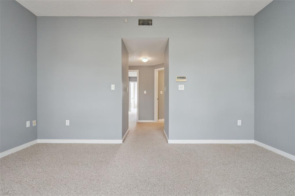720 Celebration Avenue, Unit 220 Celebration, FL 34747 - Photo 17 of 45 a view of an empty room with chandelier fan