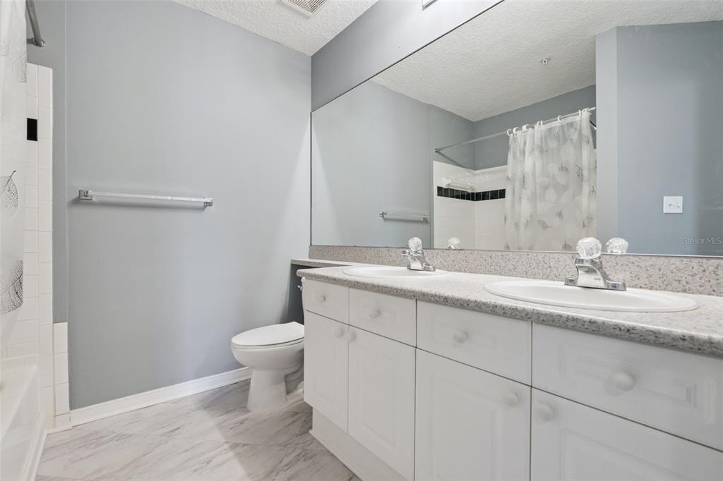 720 Celebration Avenue, Unit 220 Celebration, FL 34747 - Photo 18 of 45 a bathroom with a toilet sink and mirror