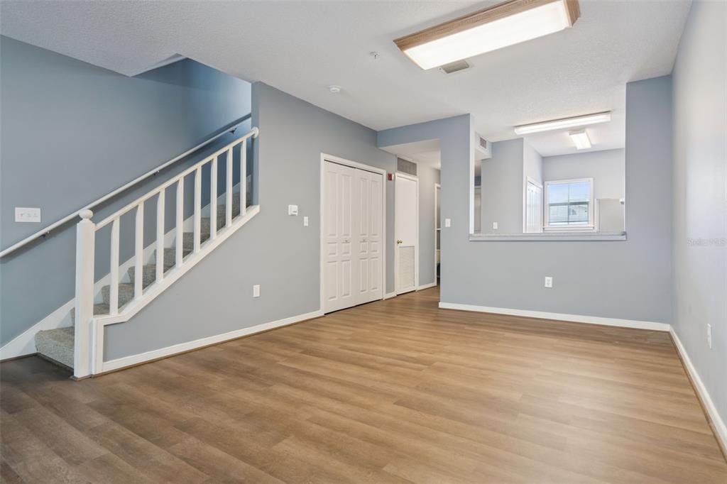 720 Celebration Avenue, Unit 220 Celebration, FL 34747 - Photo 9 of 45 a view of an empty room with wooden floor and a window