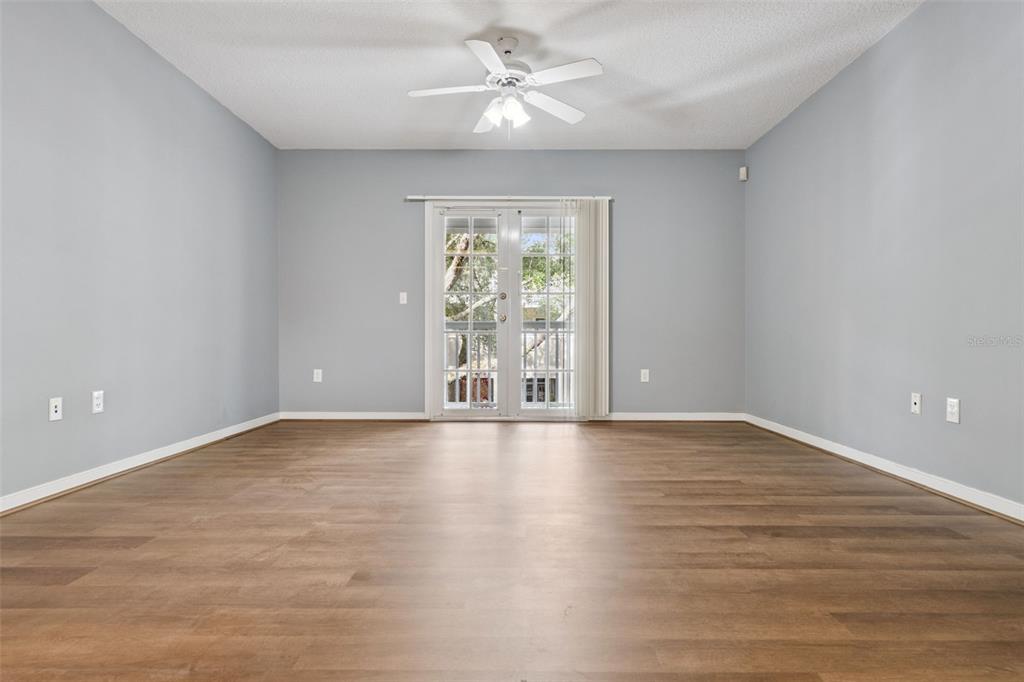 720 Celebration Avenue, Unit 220 Celebration, FL 34747 - Photo 10 of 45 wooden floor in an empty room with a window