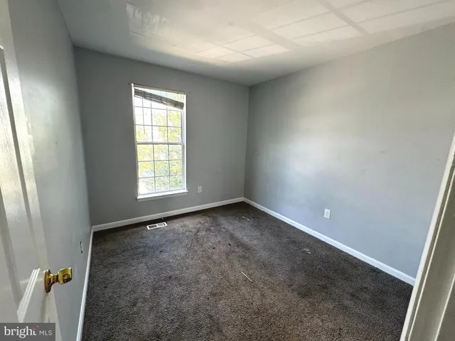 a view of an empty room and a window