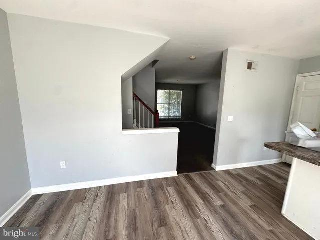 a view of a room with wooden floor and staircase
