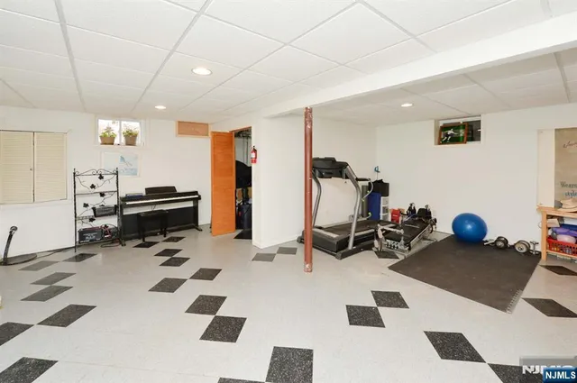 a room with furniture a rug and white walls