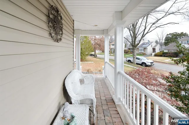 a view of a porch with furniture and garden