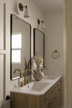 a bathroom with a double vanity sink and a mirror