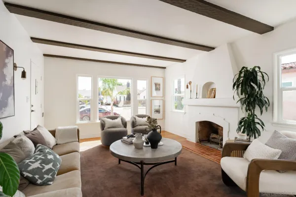 a living room with furniture a fireplace and a large window