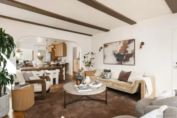 a living room with furniture and view of kitchen
