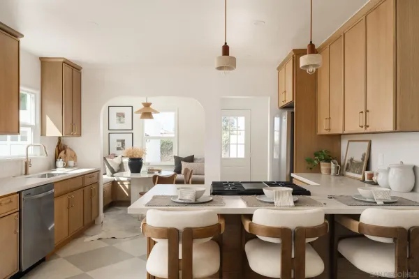 a large kitchen with a sink and living room
