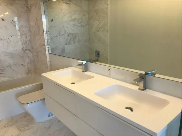 a bathroom with a sink and mirror