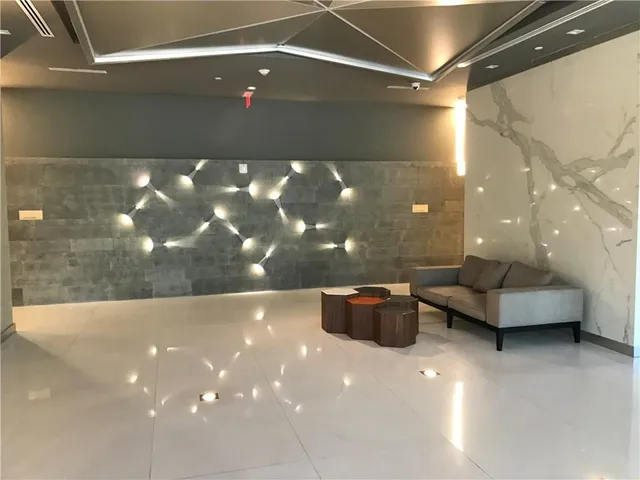 a lobby with a couch and a view