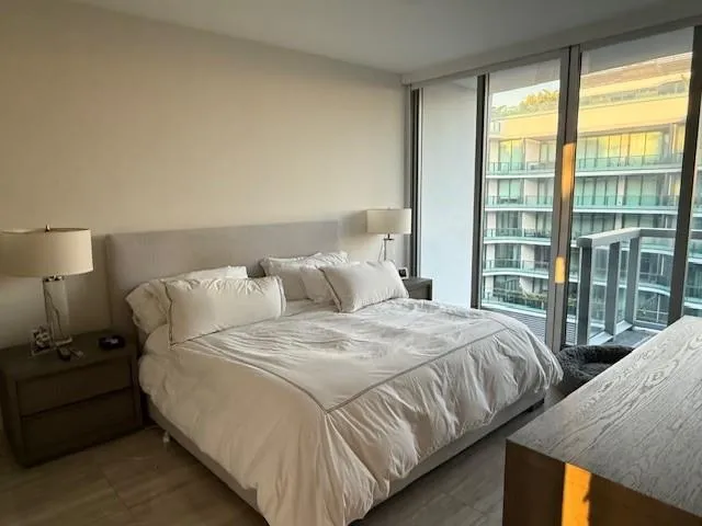 a bed sitting in a bedroom next to a window