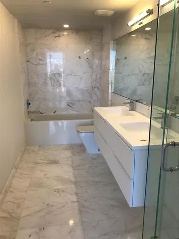 a bathroom with a bathtub and shower