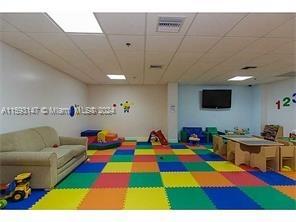 540 Brickell Key Drive, Unit 1511 Miami, FL 33131 - Photo 11 of 24 a room with furniture and a flat screen tv