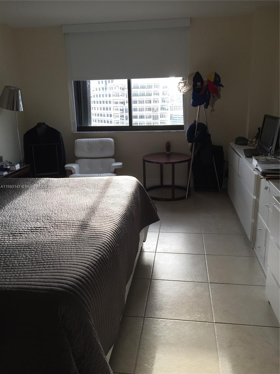 540 Brickell Key Drive, Unit 1511 Miami, FL 33131 - Photo 18 of 24 a bedroom with a bed and a window
