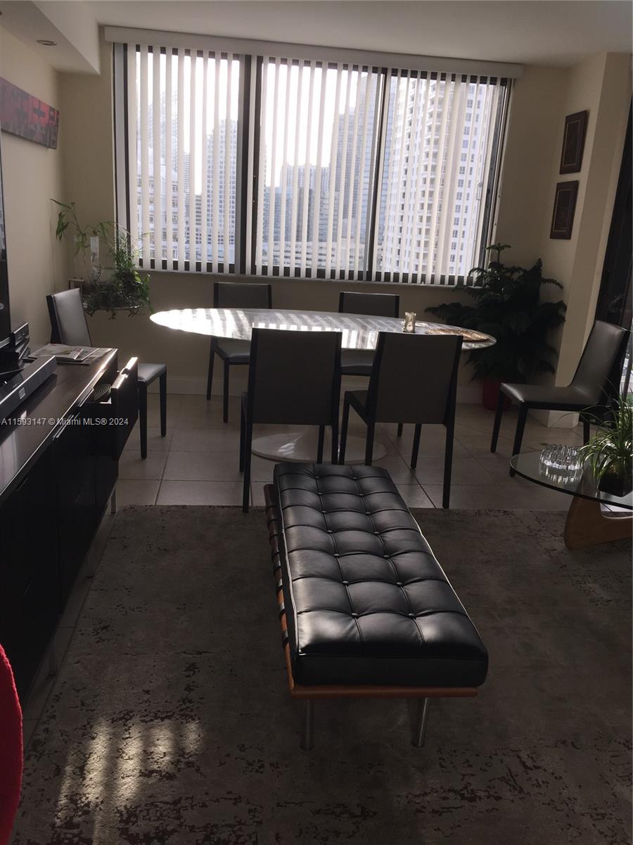 540 Brickell Key Drive, Unit 1511 Miami, FL 33131 - Photo 21 of 24 a room with furniture a rug and a window