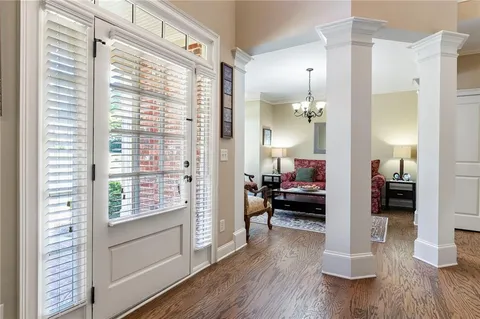 a living room with furniture fireplace and a large window