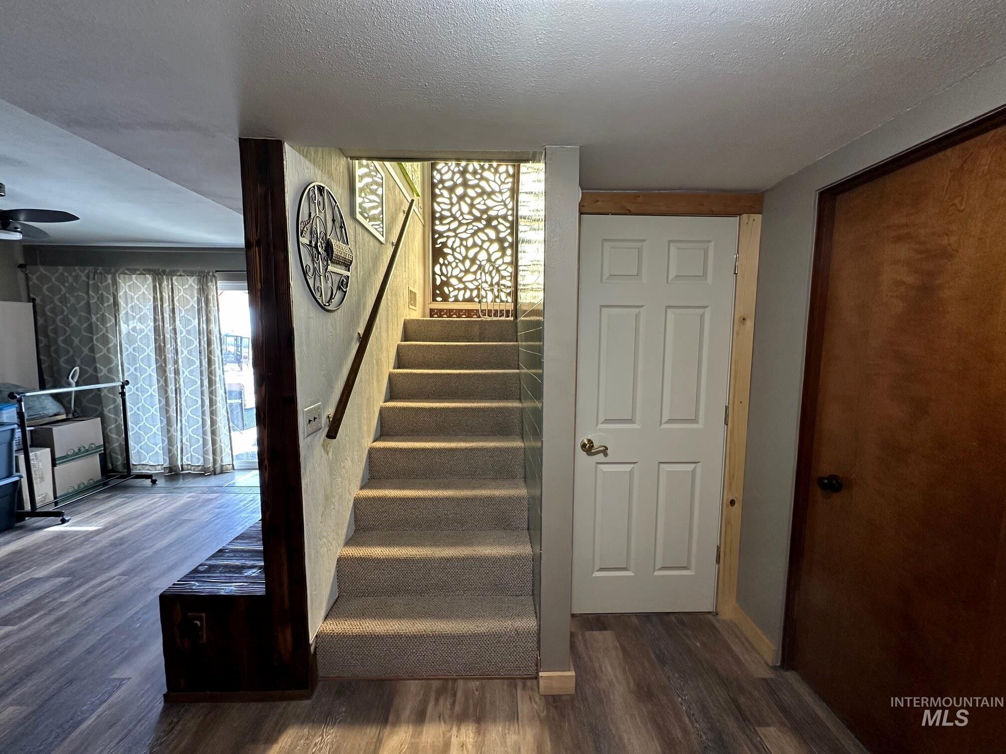 4436 Baker Road Ontario, OR 97914 - Photo 21 of 30 Stairs with wood finished floors, a textured ceiling, and ceiling fan